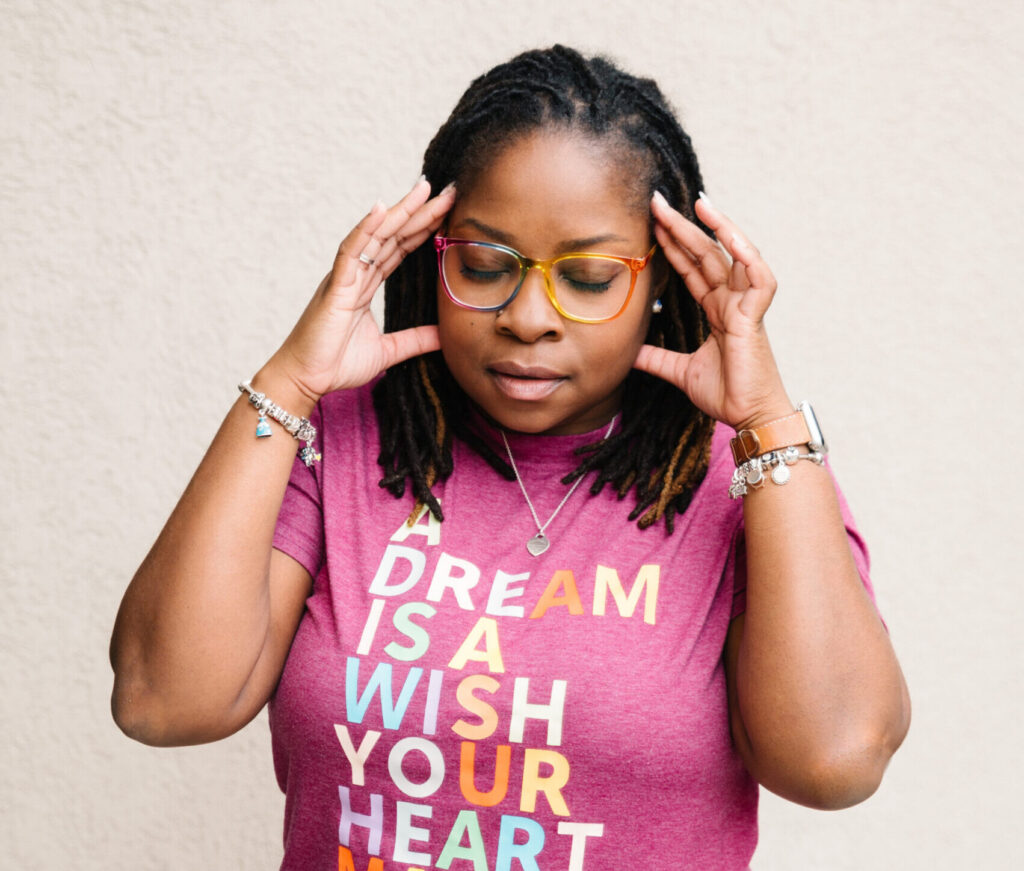 black-woman-with-fingers-on temples-looking-frustrated