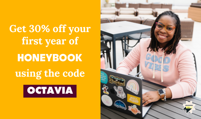 black-woman-smiling-sitting-at-table-on-laptop