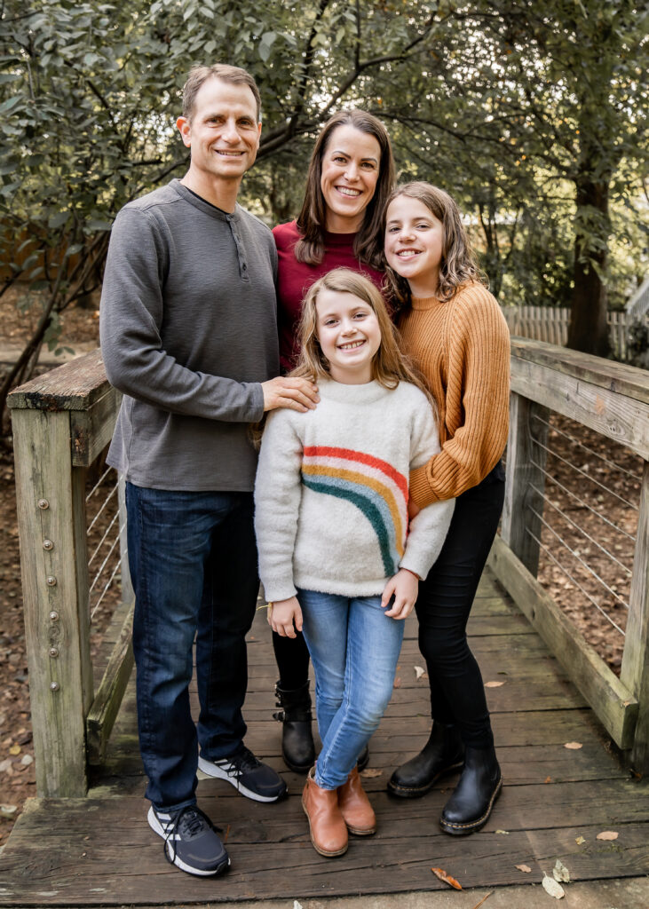family with two tween girls at the park having their fall family photo session in Atlanta, Georgia.